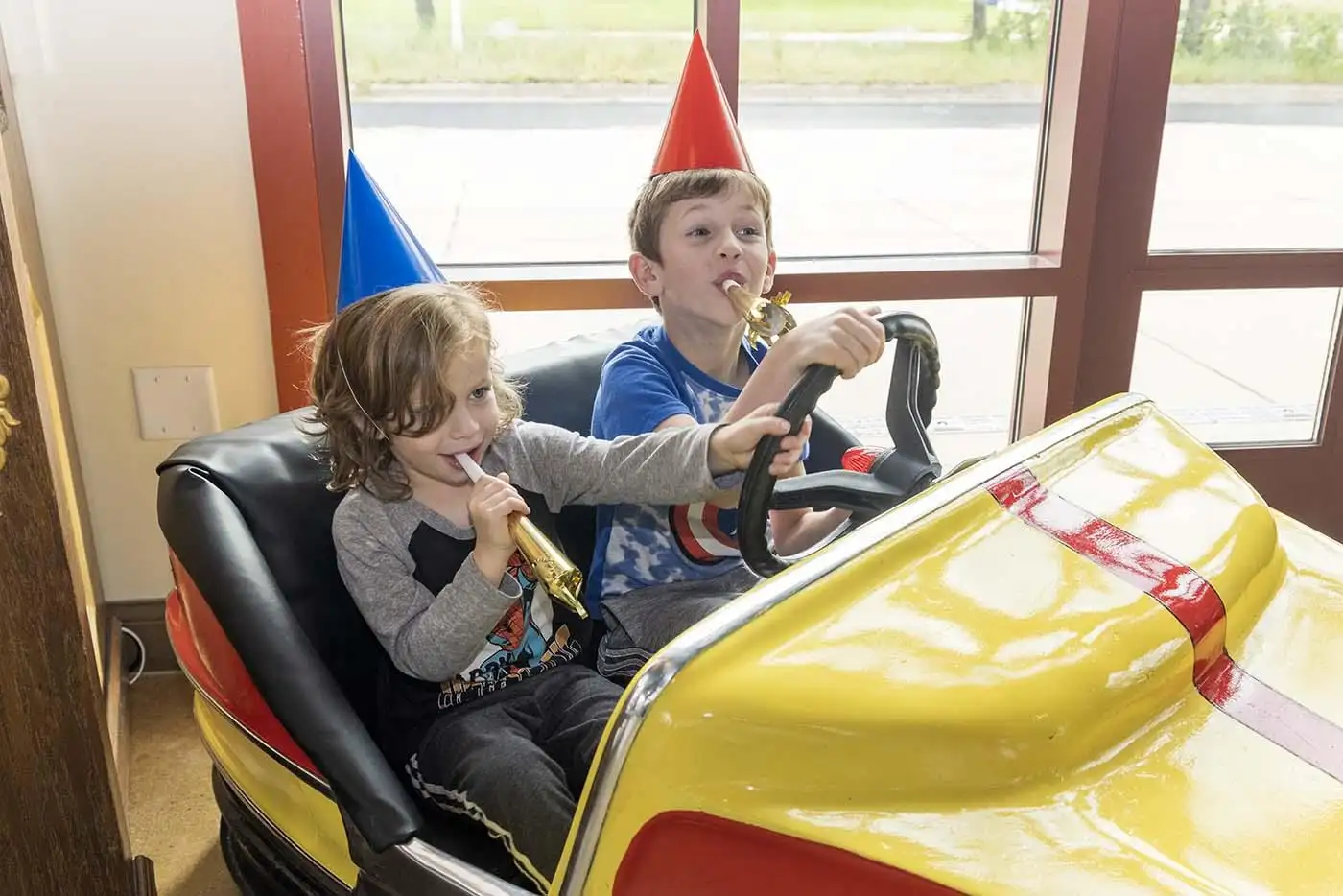 kids having fun playing in one of the cars.